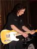 Tony Bowles strums the fretboard.  (Photo credit: Ken Stahl)
